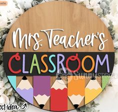 the teacher's classroom sign with pencils and flowers in the background is shown