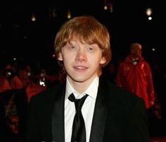 a young man in a suit and tie posing for the camera at an awards event