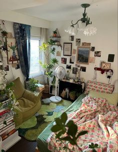 a living room filled with furniture and lots of plants on the wall next to a window