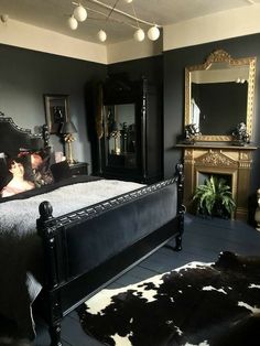 a bed room with a neatly made bed next to a mirror and a fire place