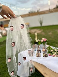 a table with pictures of people on it and some flowers in the backgroung