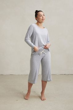 Your Comfort Uniform. Our soft and flattering raglan sleeve t-shirt paired with our capri pants with a wide soft stretch waistband and adjustable drawstring closure. Made from our signature ultra-soft and moisture-wicking fabric blend. Includes a Relaxed Long Sleeve Top and Capri Pants. Made in Canada. 93% Viscose from Bamboo / 7% Spandex. XS (0-2), S (0/2-4/6), M (6-8/10), L (10-12/14), XL (14-16/18), XXL (18-20/22). Machine washable & dryer friendly. Fabric patterns designed by and exclusive to This Is J. Fabric Patterns Design, Maternity Shops, Loungewear Sets, Pj Sets, Grey Color, Drawstring Waistband, Long Pants, Mix Match, Fabric Patterns