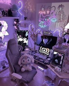 a room filled with lots of different types of furniture and decor in purple lighting, including two computer monitors