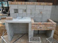 an outdoor table made out of cinder blocks and concrete grouting is being worked on