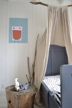 a child's bedroom with a canopy bed and small tree stumps on the floor