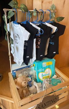 a wooden crate filled with baby items on top of a table