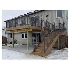 a deck with stairs and railings in front of a house