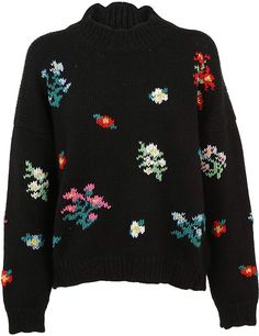 a black sweater with colorful flowers and birds on the front, it is knitted