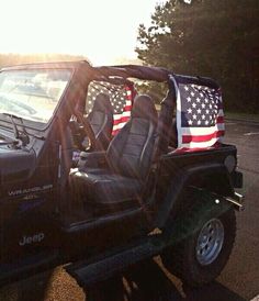 a jeep with an american flag painted on it's seat covers is parked in the parking lot