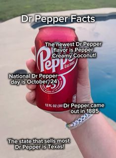 a person holding up a can of dr pepper in front of a pool with the caption