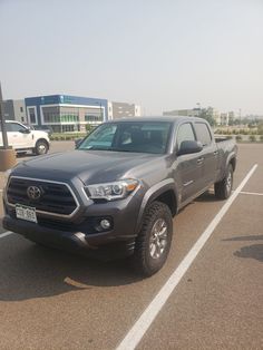 a gray toyota pickup truck parked in a parking lot