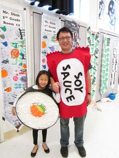 a man and woman standing next to each other in front of wall decorations with carrots on them