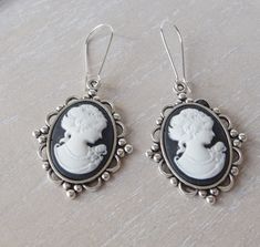 This lovely yet rose cameo earrings are just divine. This lovely piece of jewelry measures to fit a 25x18 mm cameo and comes with great antique toned french hook style dangle earrings. These gorgeous earrings measure 1 3/4 inches in length and would be the perfect gift for you or someone special. Bracelet cameo: https://www.etsy.com/listing/619538477/cameo-bracelet-silver-colored-victorian?ref=shop_home_active_1&pro=1&frs=1 All items come wrapped individually in a ribboned gift box. Please visit Handmade Gothic Wedding Earrings, Silver Cameo Earrings As A Gift, Cameo Drop Earrings For Gifts, Victorian Cameo Earrings For Gift, Black Cameo, Earrings Goth, Cameo Bracelet, Goth Earrings, Cameo Earrings