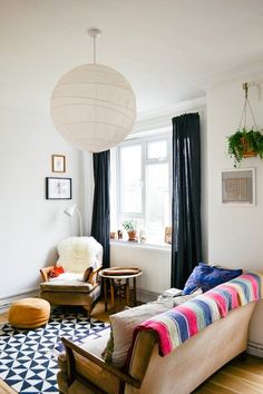 a living room filled with furniture next to a window