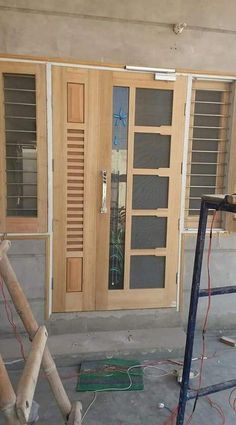 the front door is being installed and ready to be painted with wood trimmings