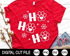 a red shirt with white dog paw prints on it and some candy canes next to it