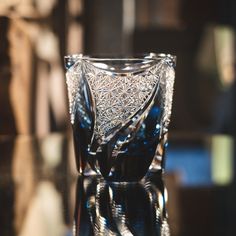 a glass vase sitting on top of a table