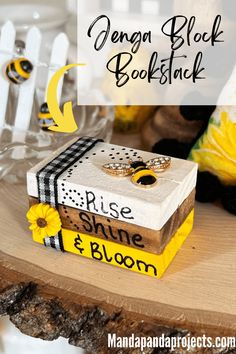 a wooden table topped with books and yellow flowers next to a vase filled with sunflowers