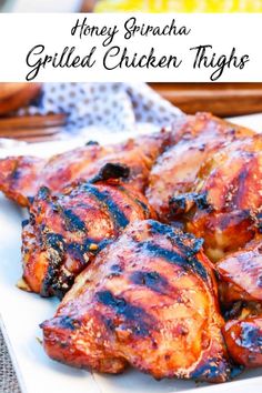 grilled chicken thighs on a white plate with honey sriraca in the background