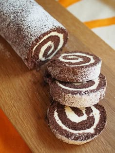 chocolate and white rolled up cookies on a cutting board