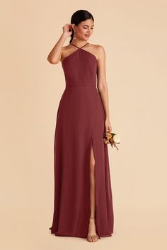 a bridesmaid in a long, halter - neck dress with side slit