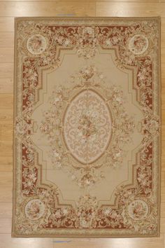 a large rug with an ornate design on top of wood flooring in a room