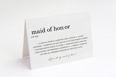 a piece of paper with the words maid of honor written in black ink on it