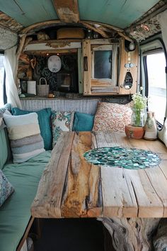 the inside of an rv with wooden tables and couches