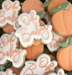 some decorated cookies are sitting in a box with leaves and pumpkins on top of them