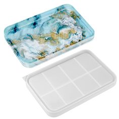 a blue and white tray with compartments for food on the bottom, next to it's lid