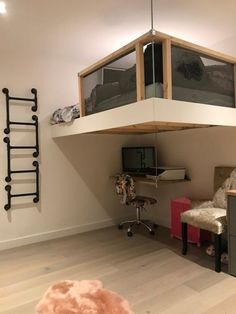 there is a loft bed in the corner of this room with a desk and chair