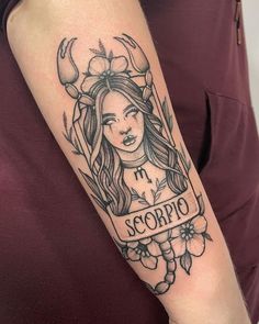 a woman's arm with a tattoo on it that says scorpiono and flowers