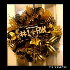 a new orleans saints fan wreath with the number one fan on it's front door