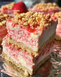 strawberry shortcakes are stacked on top of each other and topped with crumbs