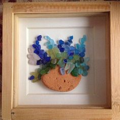 there is a frame with some flowers in it