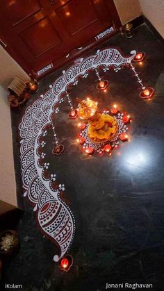 a decorated floor with candles on it and an intricately designed design in the middle