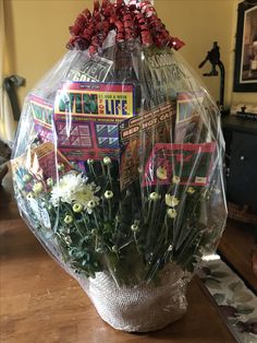 a vase filled with flowers on top of a wooden table