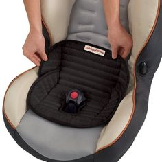 a woman is holding her baby in a car seat with the child's safety belt attached