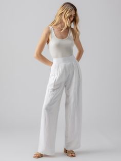 DETAILS Pleated Wide Leg Trousers with Elastic Back Waistband 2 Front and 2 Back Pockets Pull-On Relaxed Fit SIZE + FIT Model is 5'8" and is wearing a size 27. Waist: 29 1/2" Front Rise: 13 1/4" Inseam: 32" Leg Opening: 24" FABRIC + CARE Shell: 54% Linen 46% Viscose Lining: 100% Cotton Polished Linen Machine Wash Cold, Hang to Dry Imported MADE WITH SUSTAINABILITY IN MIND Flax is the second most highly productive crop (after hemp). Flax can successfully grow without the use of herbicides and pes Cheap White Utility Bottoms, Cheap White Casual Harem Pants, Cheap White Bottoms For Everyday, Cheap White Pants For Spring, Cheap White Capris With Elastic Waistband, Cheap White Leisure Bottoms, Cheap White Drawstring Pants, Cheap Linen Straight Leg Bottoms, Cheap White Bottoms With Hip Pockets