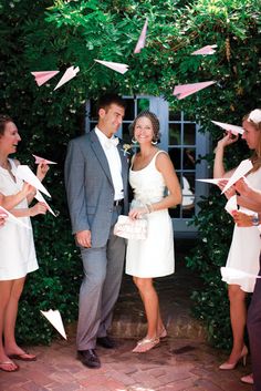 a bride and groom are surrounded by confetti