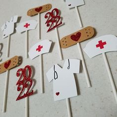 the cake toppers are decorated with red and white numbers, hearts, and bandages