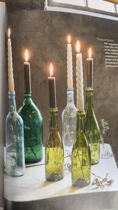 an open magazine with candles in glass bottles