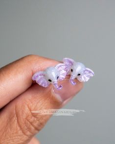 These cute and dainty elephant earrings are based on the majestic African elephants. They are available in 2 different colors. Both are gorgeous in their own way. The white sparkly elephant has a light purple tint and accented with purple shadows. The green elephant is a beautiful teal color with gold flakes. These elephant measure 1.5 cm across and 1.1 cm head to trunk. They are dainty and lightweight. The earring posts are stainless steel and the nuts are plastic. Please note that colors may appear different from screen to screen. Price shown is for 1 pair. International mail processing and delivery can be unpredictable. Your patience and support is truly appreciated but please do not order if you are in a hurry. I ship from Malaysia and mail to international destinations can take anywhe Elephant Earrings Studs, Green Elephant, Dainty Jewellery, Resin Accessories, Elephant Jewelry, Elephant Earrings, Jewellery Handmade, African Elephant, Cute Elephant