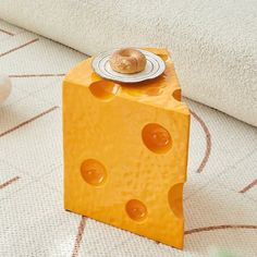 a piece of cheese sitting on top of a floor