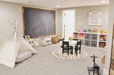 a child's playroom with teepee tent and toys