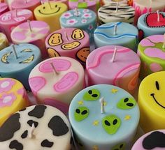 many different colored candles with smiley faces on them