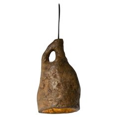 a brown stone light hanging from a cord