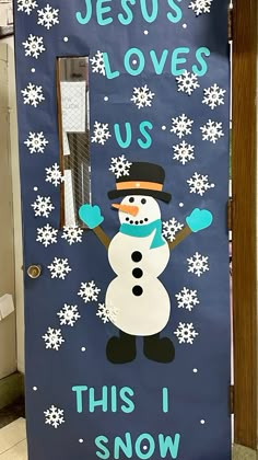 a door decorated with a snowman and the words jesus loves us, this i snow