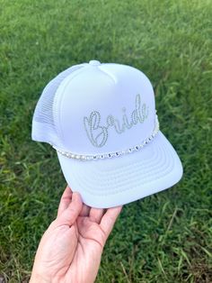 Make a sparkling statement at your bachelorette party or wedding events with this eye-catching rhinestone "Bride" trucker hat! Features: - Classic trucker hat style with mesh back for breathability - Front panel adorned with "Bride" in dazzling rhinestones - Adjustable snapback for a perfect fit - Color: White front panel with white mesh back -other colors available upon request - High-quality rhinestones securely attached for long-lasting shine Perfect for: - Bachelorette parties - Bridal showe Bachelorette Party Shots, Custom Denim Jacket, Miss To Mrs, Bridal Accessory, Custom Denim, Richmond Hill, Hat Style, Honeymoon Travel, White Mesh