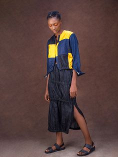 On a mission to express the creativity and individuality of women through fashion, Nigerian label Gozel Green present this statement skirt from their SS’22 collection. Crafted from structured denim in an inky hue, it has a figure-hugging silhouette enhanced by elastic ruched detailing and side slits for easy movement. Wear it with a tucked-in sweater and loafers for daytime, switching to a silk blouse and sling-backs to go from desk to dinner. - High waist, elastic ruched detailing, mid-calf len Green Denim Skirt, African Luxury, Patchwork Denim Jacket, Statement Skirt, Hugging Silhouette, Patchwork Denim, Denim Patchwork, Mini Shift Dress, Skirted Swimwear